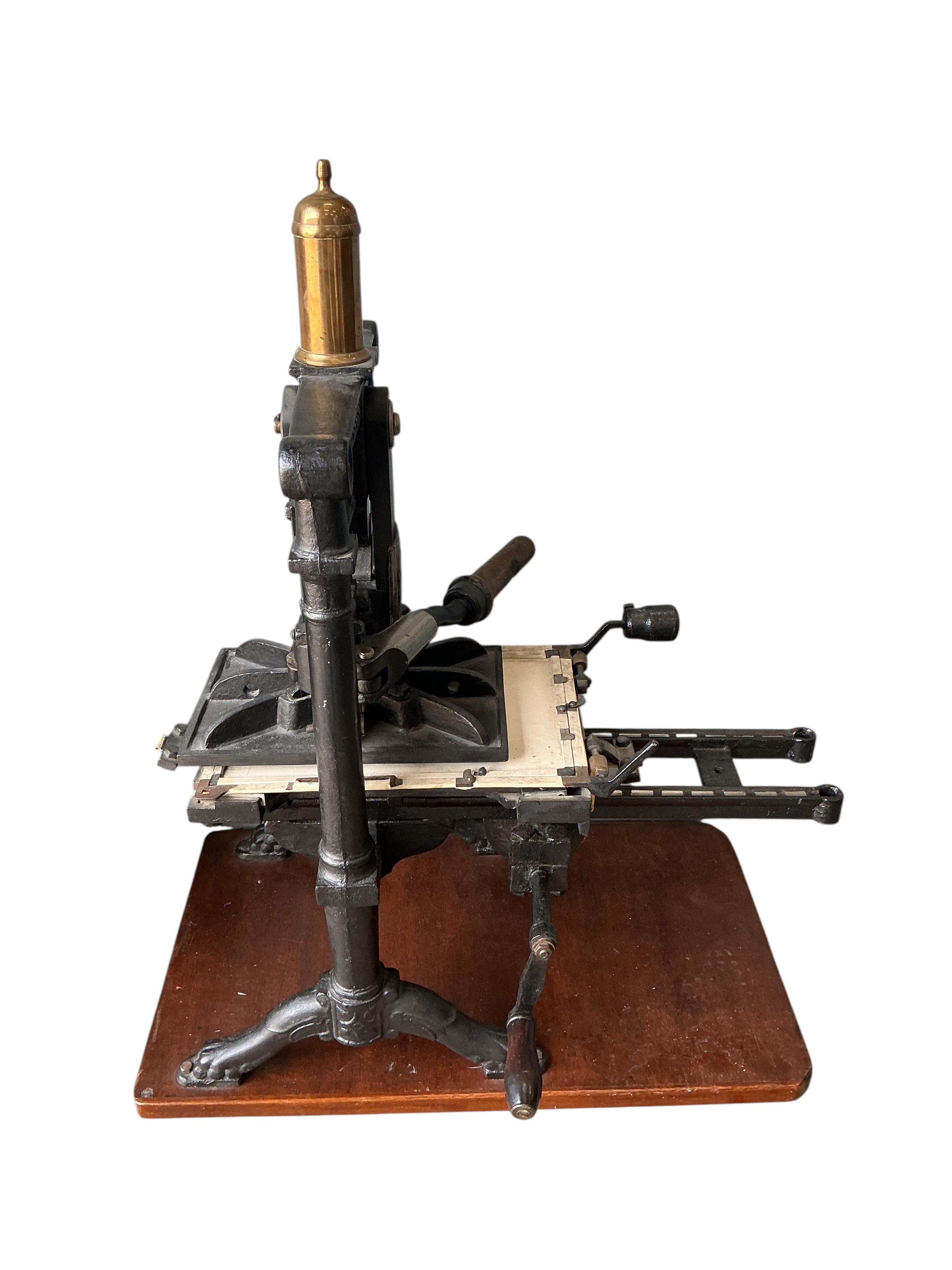 A Victorian cast iron Albion printing press by Wood and Sherwood, Aldersgate Street, London, width 87cm, height 105cm, together with a stained pine chest of print making accessories. Provenance: This was the property of